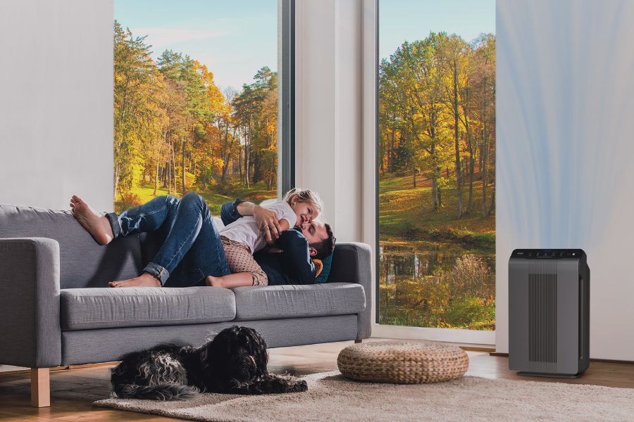 5300-2 air purifier on the floor next to dog and parent and child playing in a living room