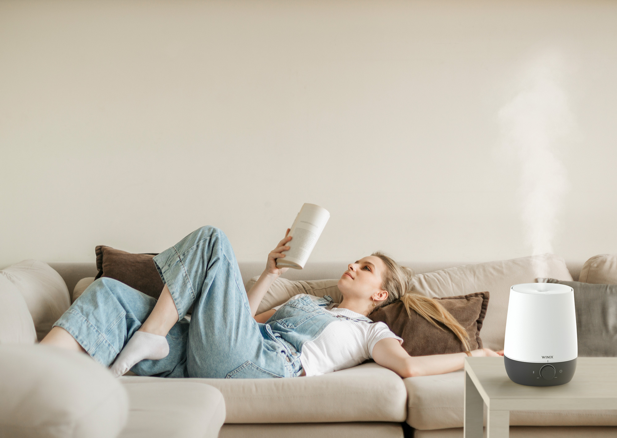 L61 Humidifier on coffee table next to woman relaxing on a couch