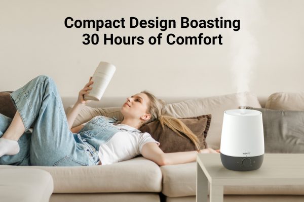 L61 Humidifier on coffee table next to woman relaxing on a couch and text saying compact design boasting 30 hours of comfort