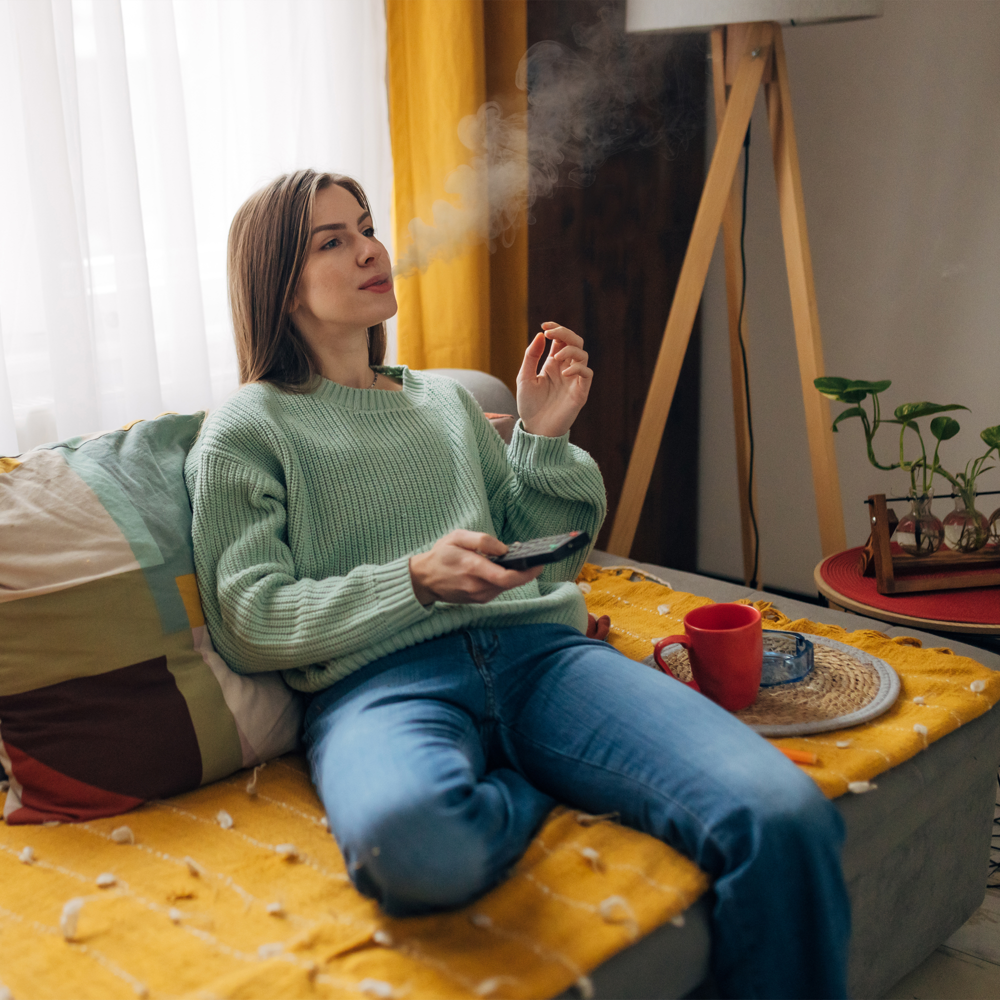 Woman sitting on couch enjoying a smoke